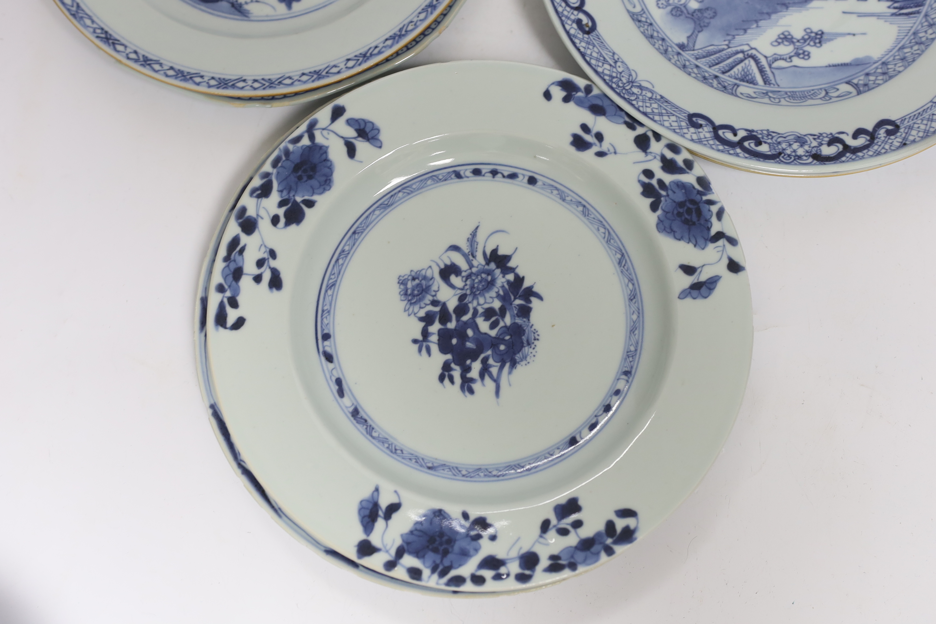 Six Chinese blue and white plates, 18th century and a Kangxi blue and white bowl and wood stand